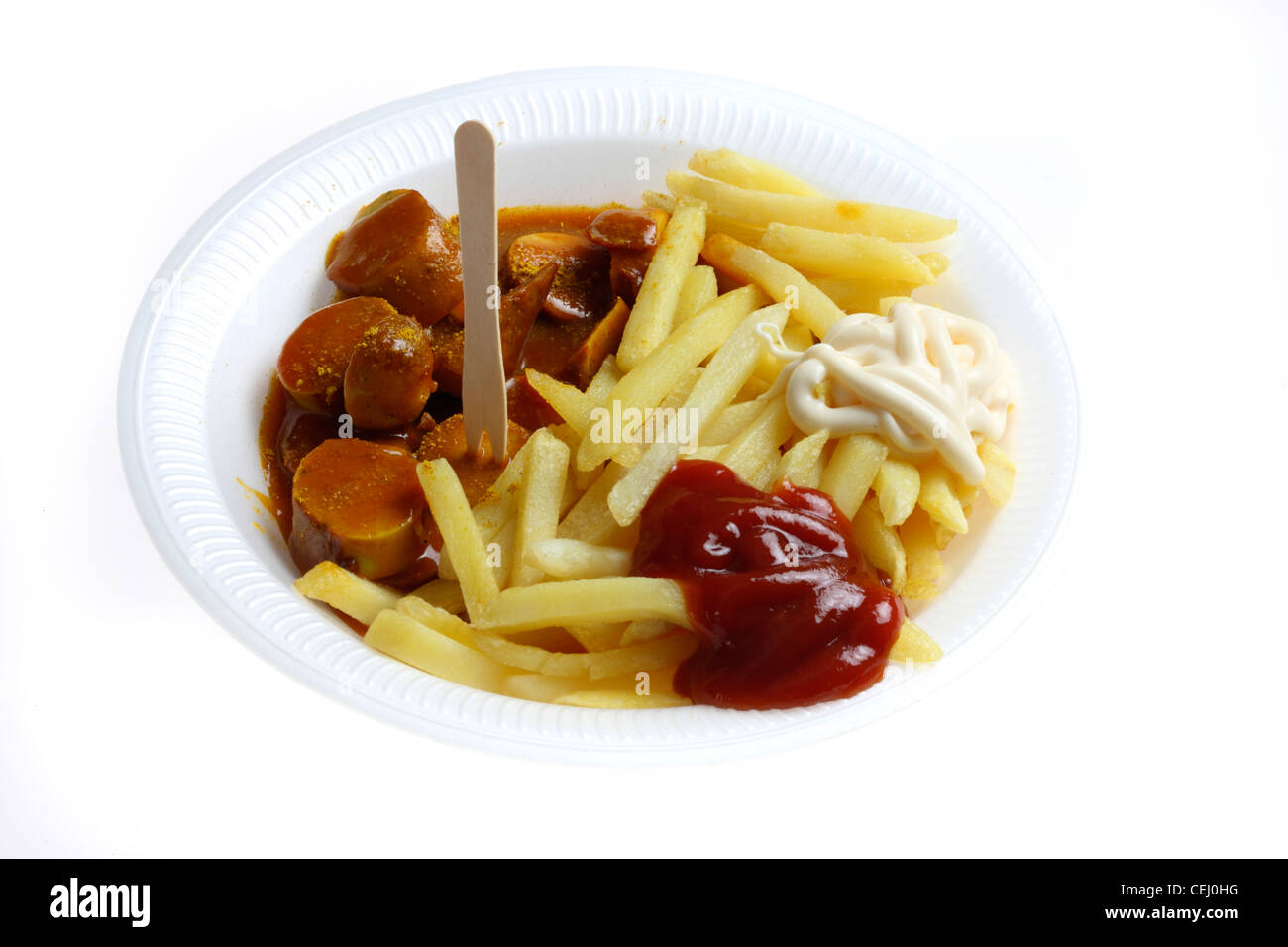 Nutrition, fast food. French fries with a  curry wurst, a Bratwurst style sausage with a spicy curry and tomato sauce. Stock Photo