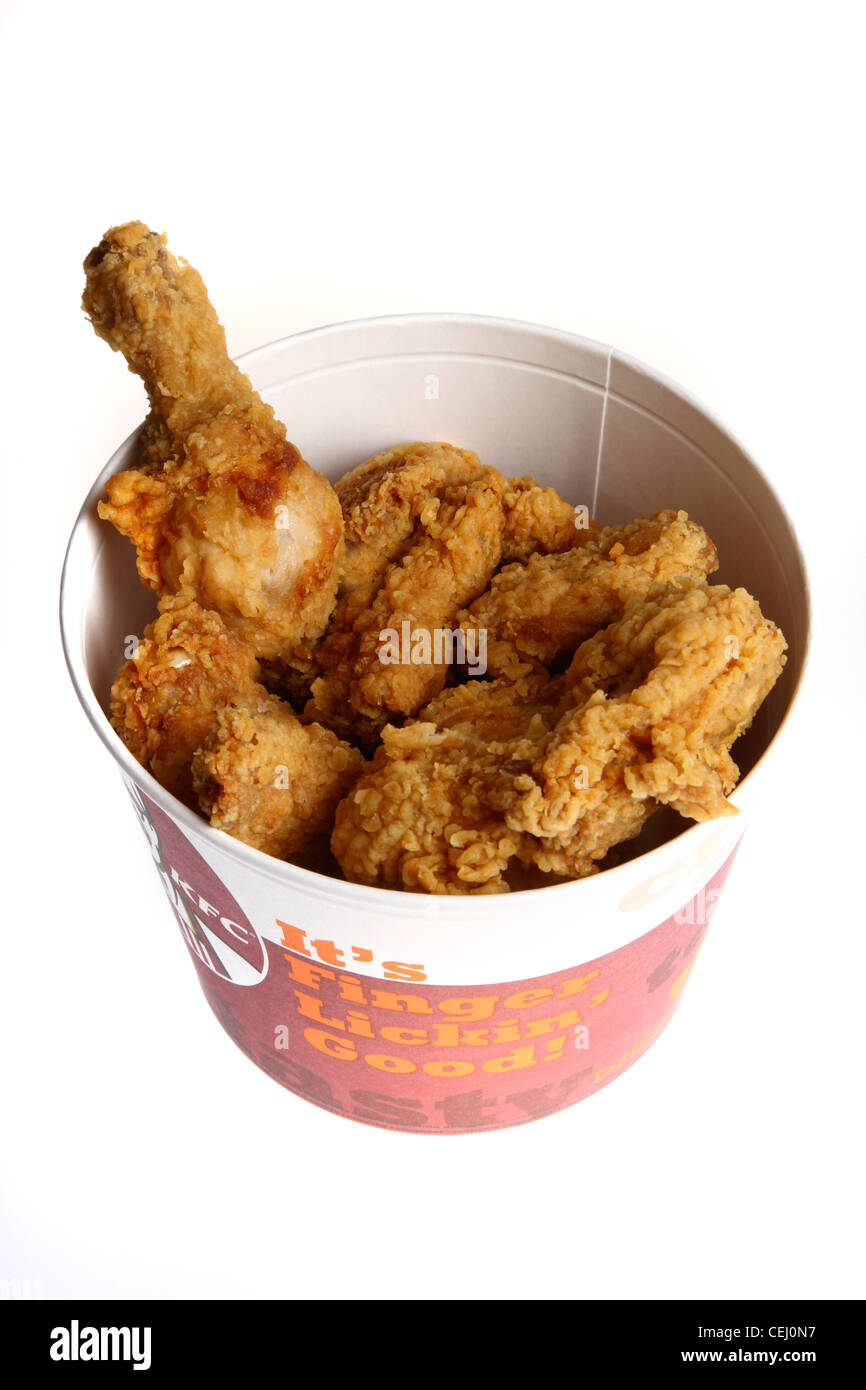 Nutrition, fast food. Paper bucket, full with chicken pieces, legs, wings, filet's, meat, breaded. KFC Fast food chain. Stock Photo