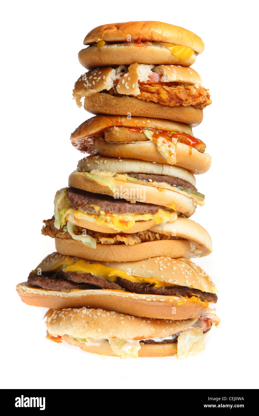Nutrition, fast food. Many different hamburgs, cheeseburger, chicken burger, fish burgers, vegie, vegetable burgers, stacked. Stock Photo