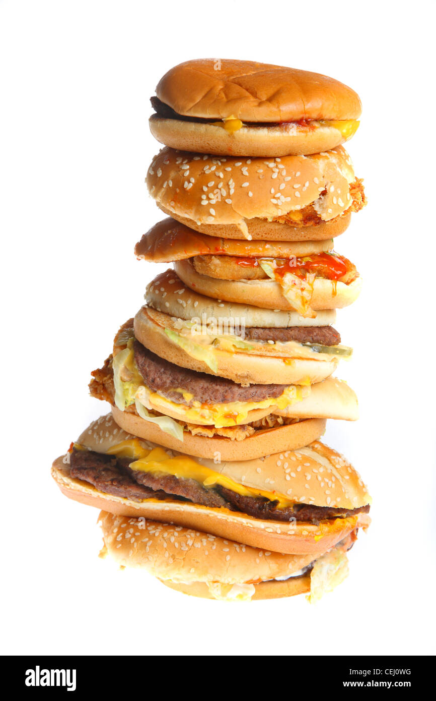 Nutrition, fast food. Many different hamburgs, cheeseburger, chicken burger, fish burgers, vegie, vegetable burgers, stacked. Stock Photo