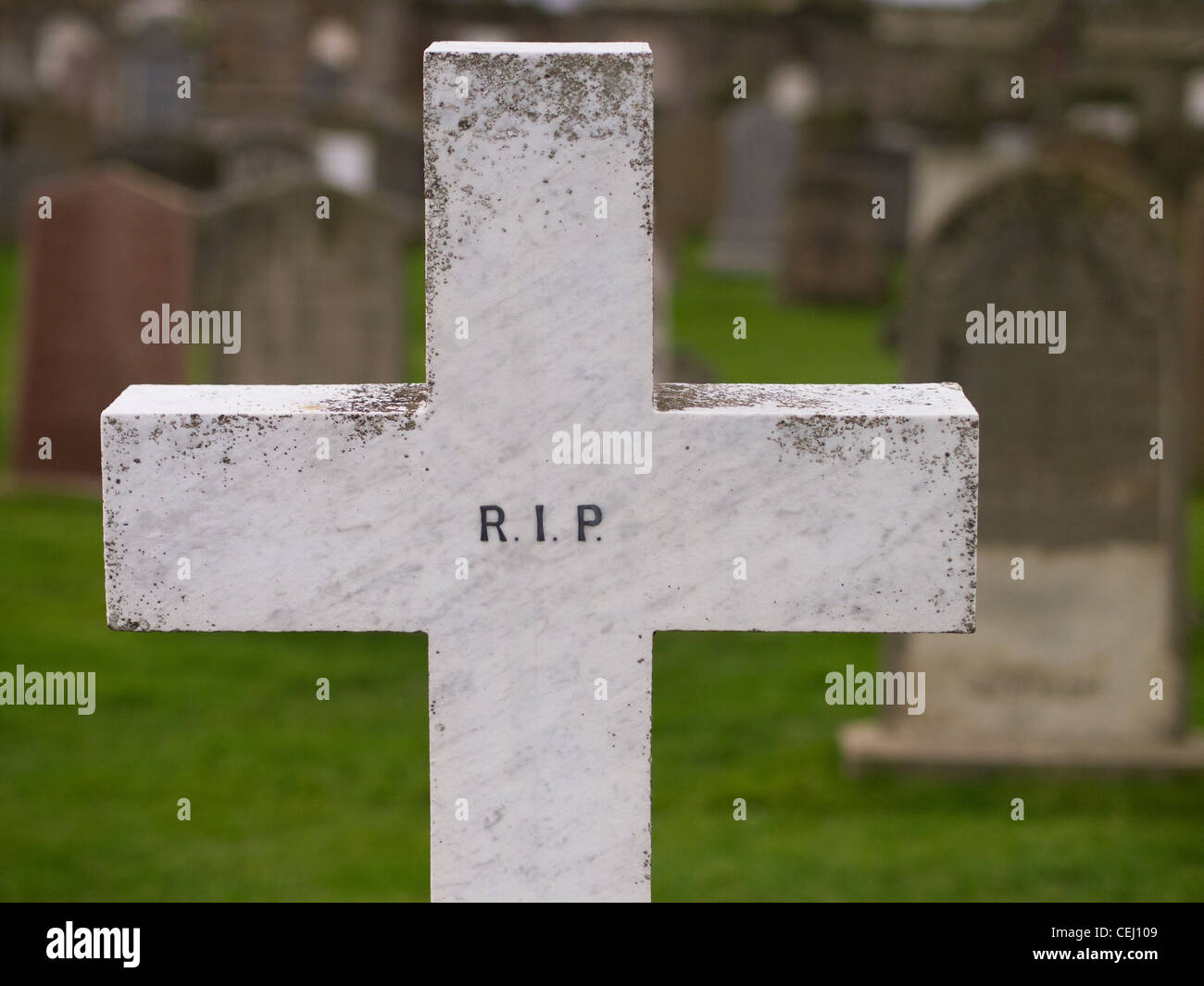 White Cross Gravestone with the Letters RIP Stock Photo