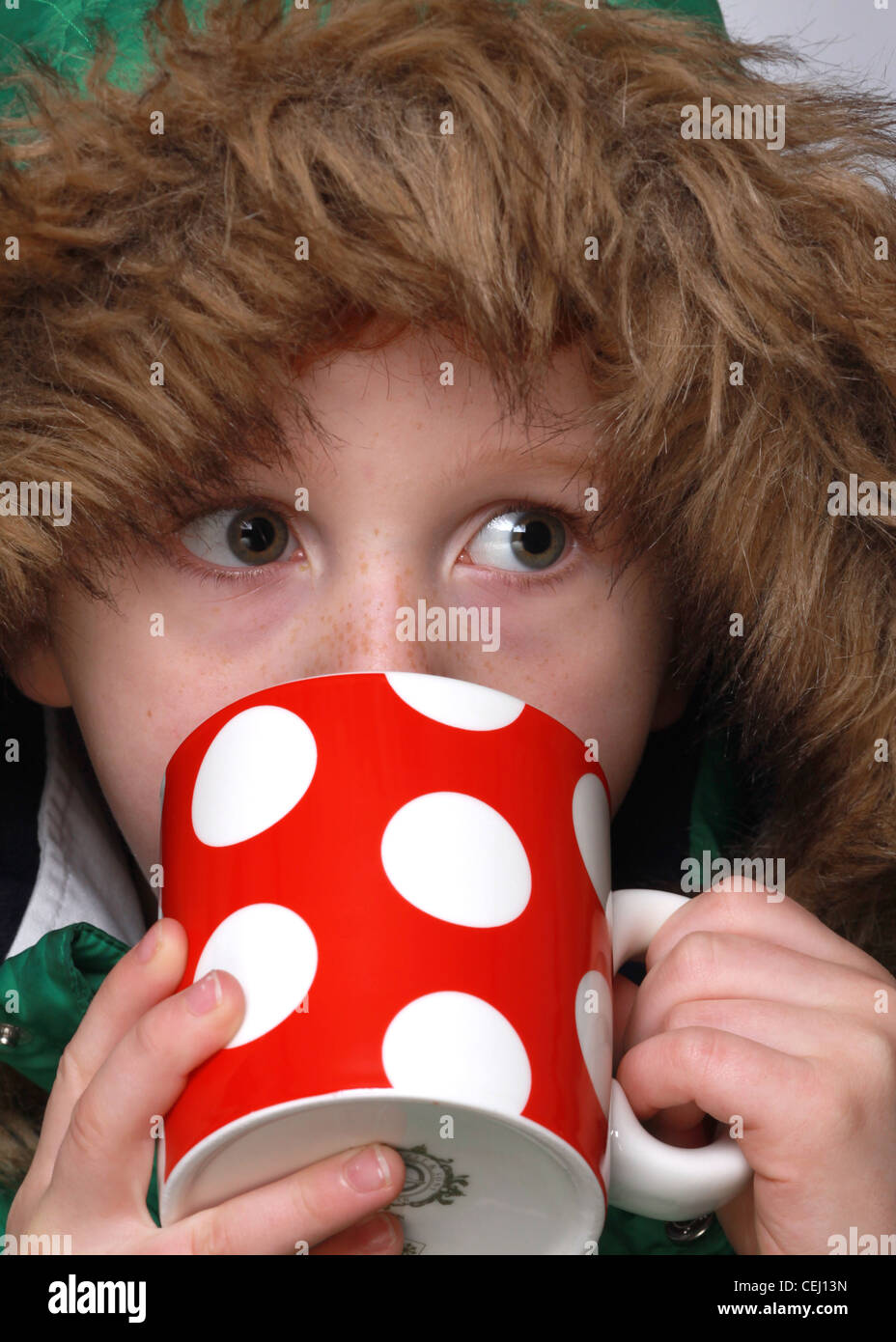 Children drinking from mugs, cold concepts Stock Photo