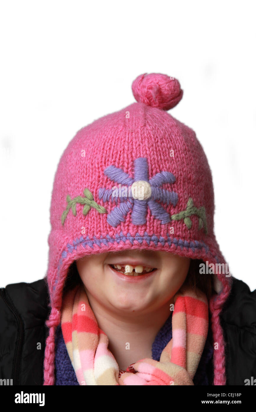 Comical image of female child in Studio hiding under a hat Stock Photo