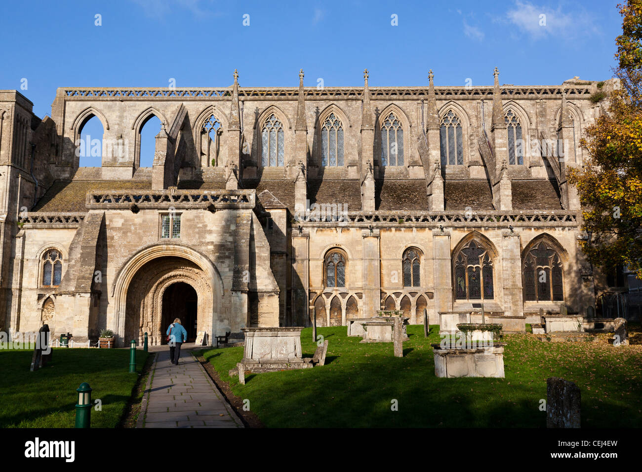 Malmesbury Abbey with its Norman south porch. The earliest parts of the building date from the 12th century. Stock Photo