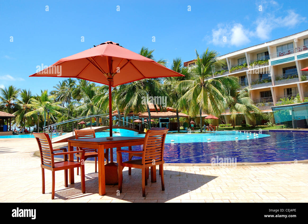 The table and chairs of outdoor restaurant near swimming pool at luxury