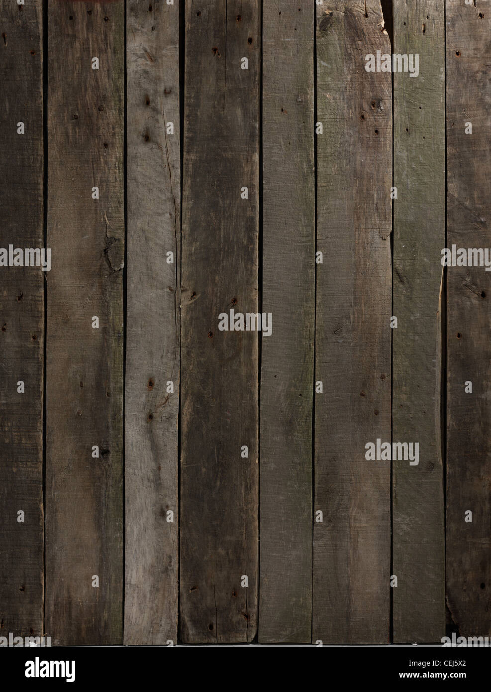 Old wood panel background with shaft of light illuminating middle section Stock Photo