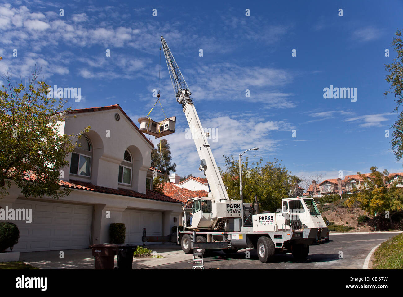 Crane lifting house hires stock photography and images Alamy
