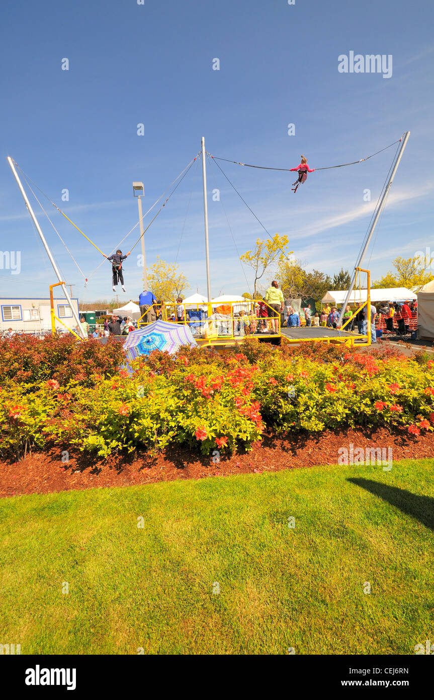 Bungee jumping ride at a carnival.  People having fun. Stock Photo