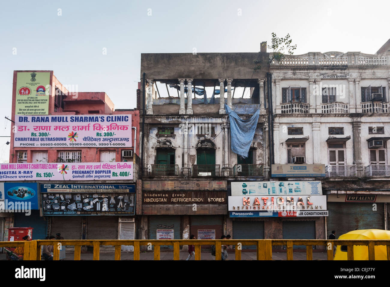 Indian third world urban lifestyle: Street life and view of old, dilapidated apartment and shop buildings in Old Delhi, India Stock Photo