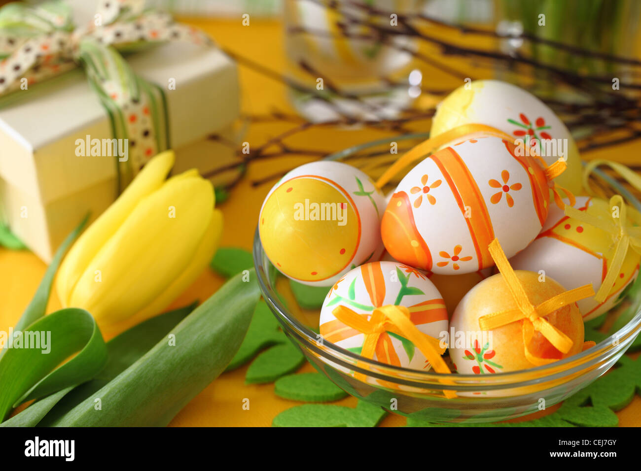 Closeup of easter eggs and yellow tulip on table Stock Photo - Alamy