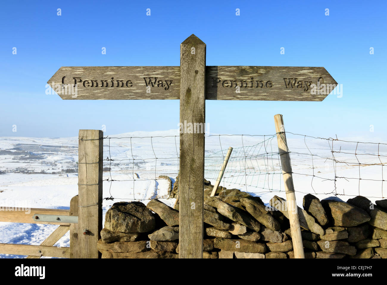 A Pennine Way sign post on a snow covered Pen-y-ghent, in the Yorkshire Dales national park. Stock Photo
