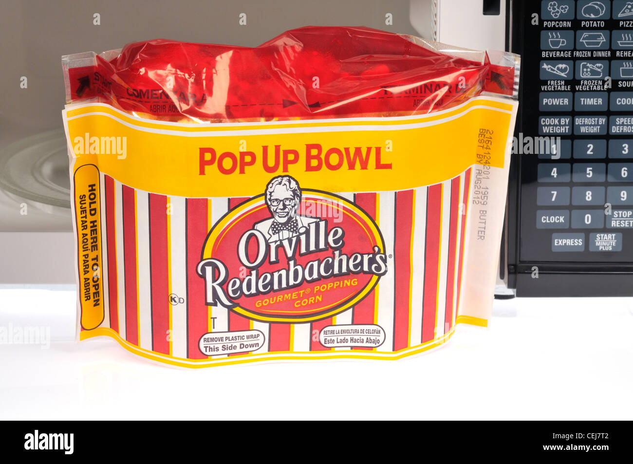 Popup Bowl of Orville Redenbacher microwave popcorn in front of microwave oven Stock Photo