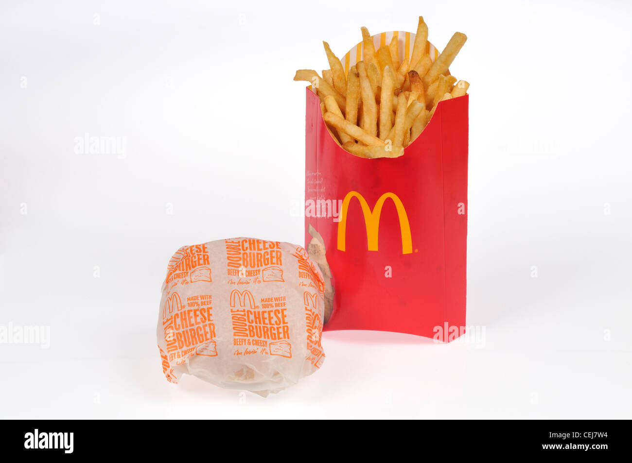 McDonalds double cheeseburger in paper wrapper with large french fries on white background USA Stock Photo