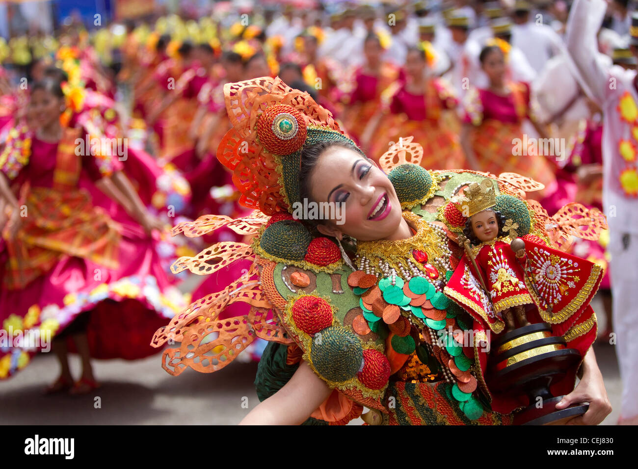 Lead dancer performs street dance routine holding Santo Nino, Sinulog Grande Parade 2012 Stock Photo