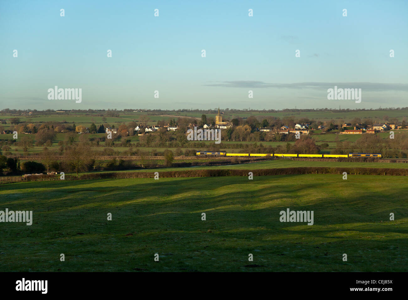 66736 tnt 66717 with 5 jna wagons pass between Rotherby and Hoby (background) villages 6H66 08.28 Peterborough - Derby Stock Photo
