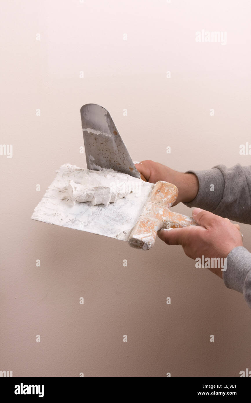 Putty Knife with Paste to repair damaged wall Stock Photo Alamy