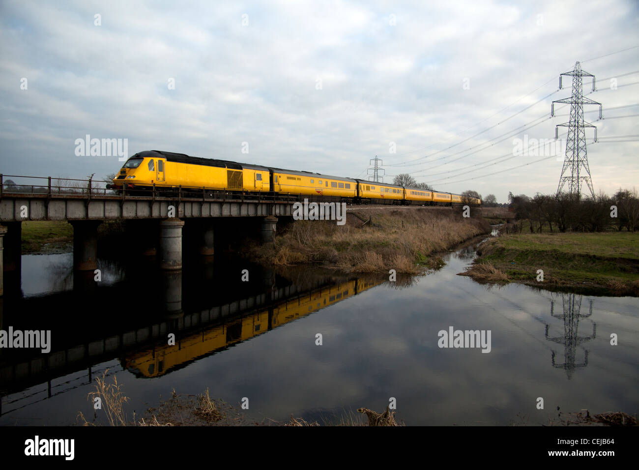 Network Rail New Measurement High Speed train (HST) crossing and reflecting in the River Soar, Normanton on Soar, Loughborough. Stock Photo