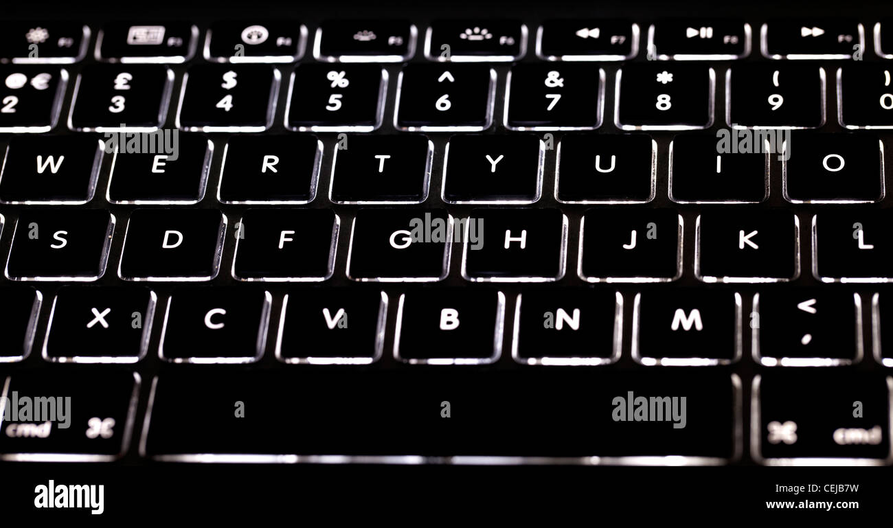 Closeup Of Backlit Laptop Keyboard Keys Glowing Stock Photo