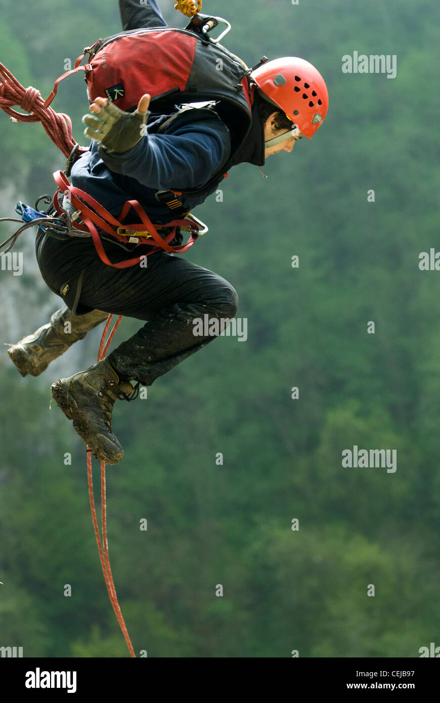 Rope jumper (bungee jumper) performing a jump into hundred meters deep canyon in Caucasus mountains, Russia Stock Photo