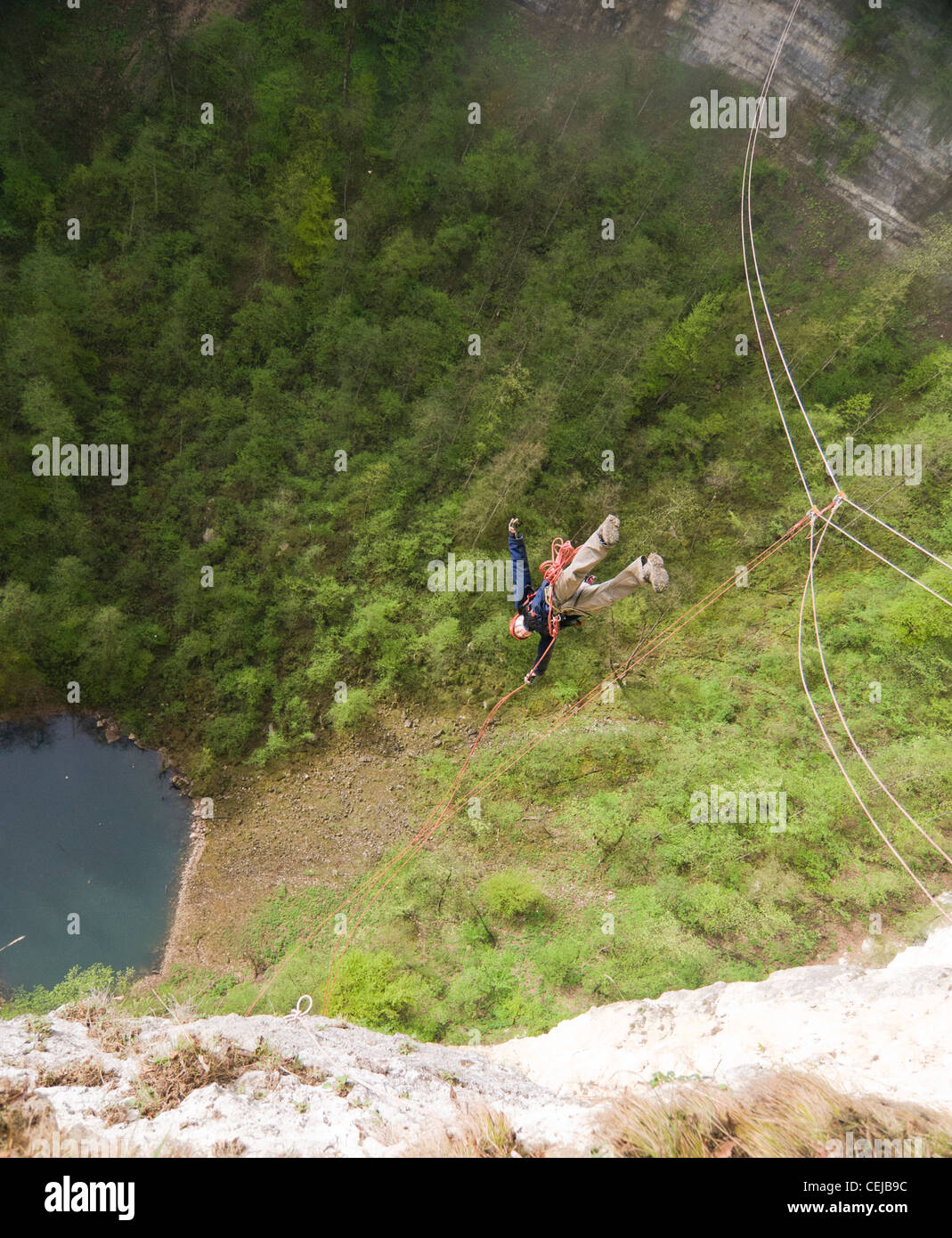 Rope jumper (bungee jumper) performing a jump into hundred meters deep canyon in Caucasus mountains, Russia Stock Photo