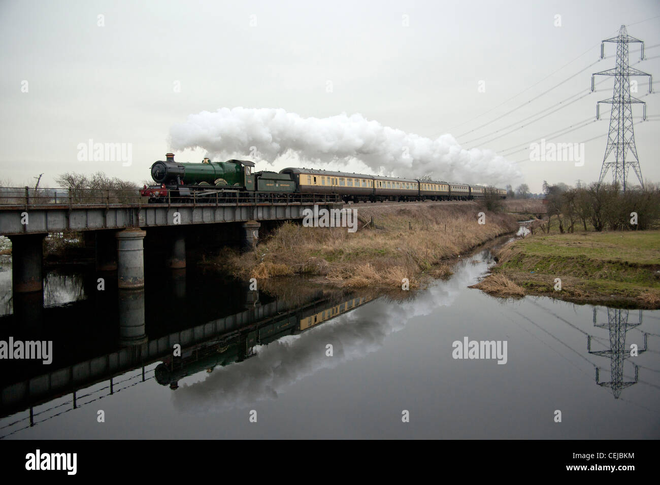 GWR Hall class locomotive 4965 'Rood Ashton Hall' crosses and reflects in the River Soar at Normanton On Soar, Loughborough Stock Photo