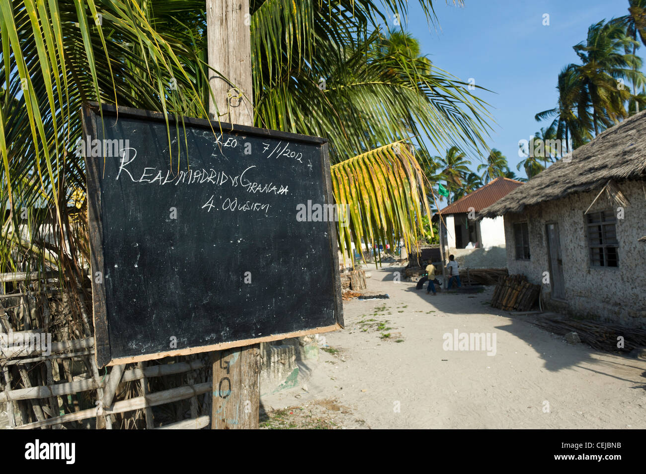 Blackboard advertisement to watch a football match on TV in Bwejuu village east coast of Zanzibar Tanzania Stock Photo