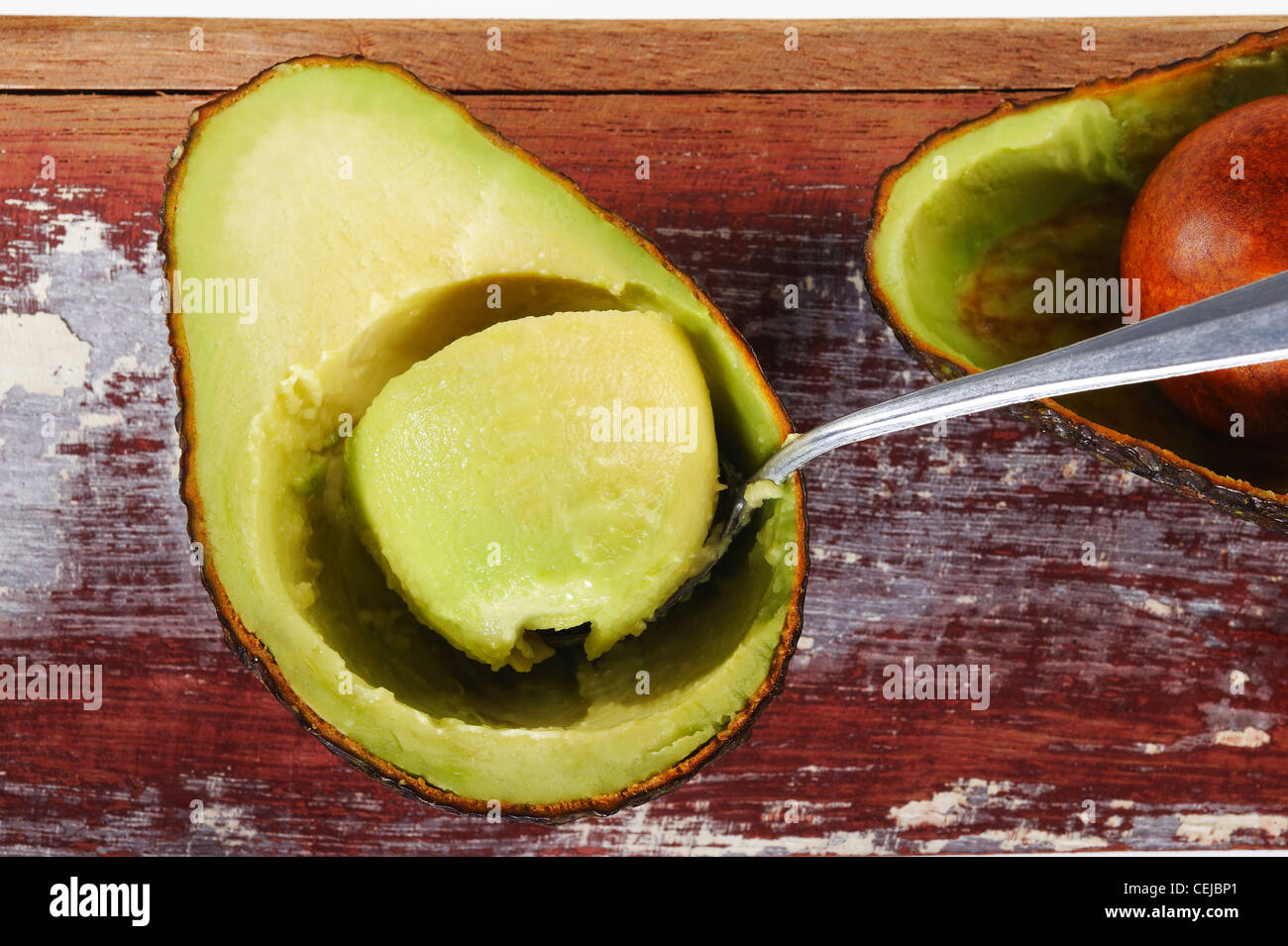 ripe cut avocado on wooden Stock Photo