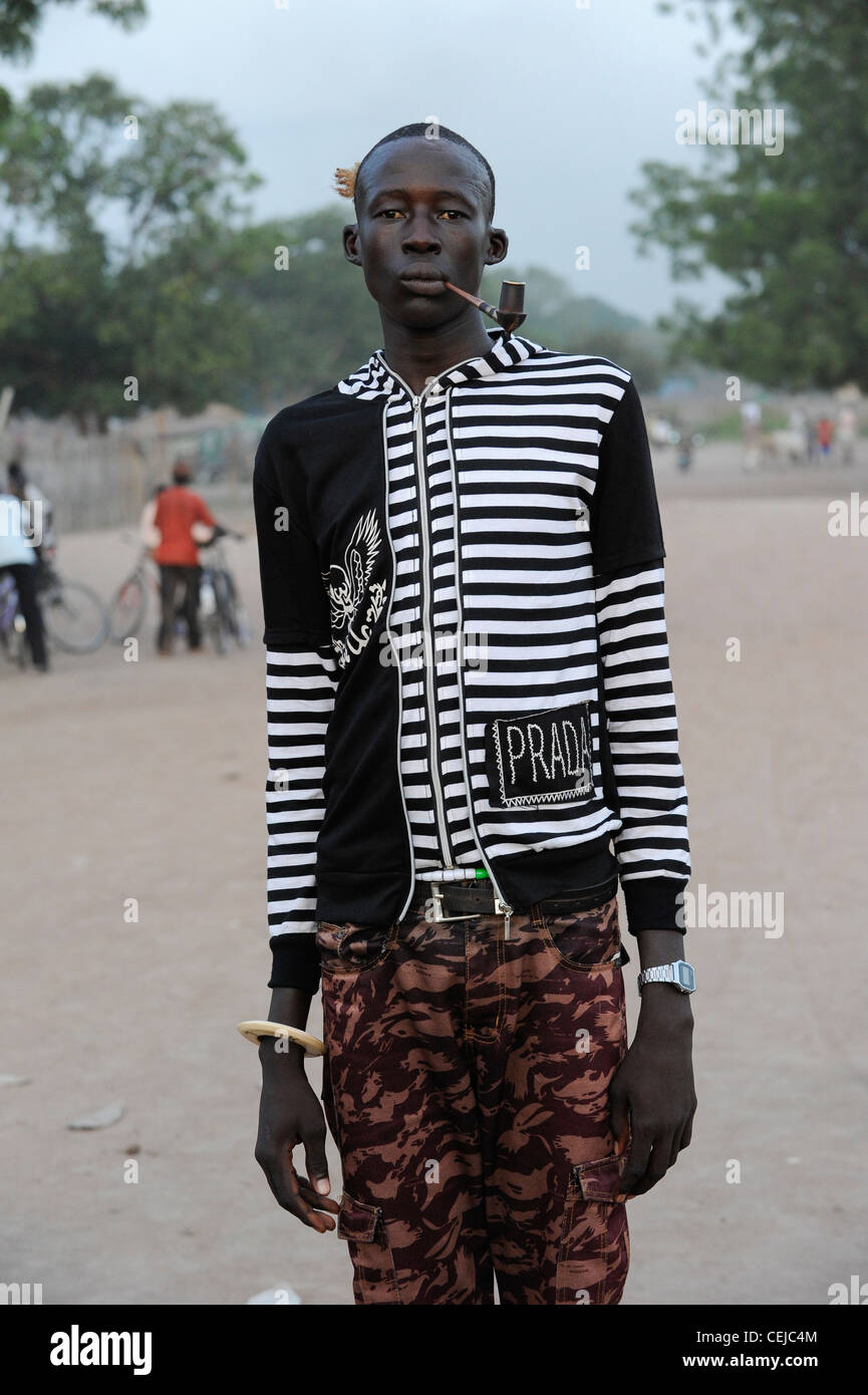Africa SOUTH-SUDAN Rumbek Dinka man with pipe in Prada pullover Stock Photo