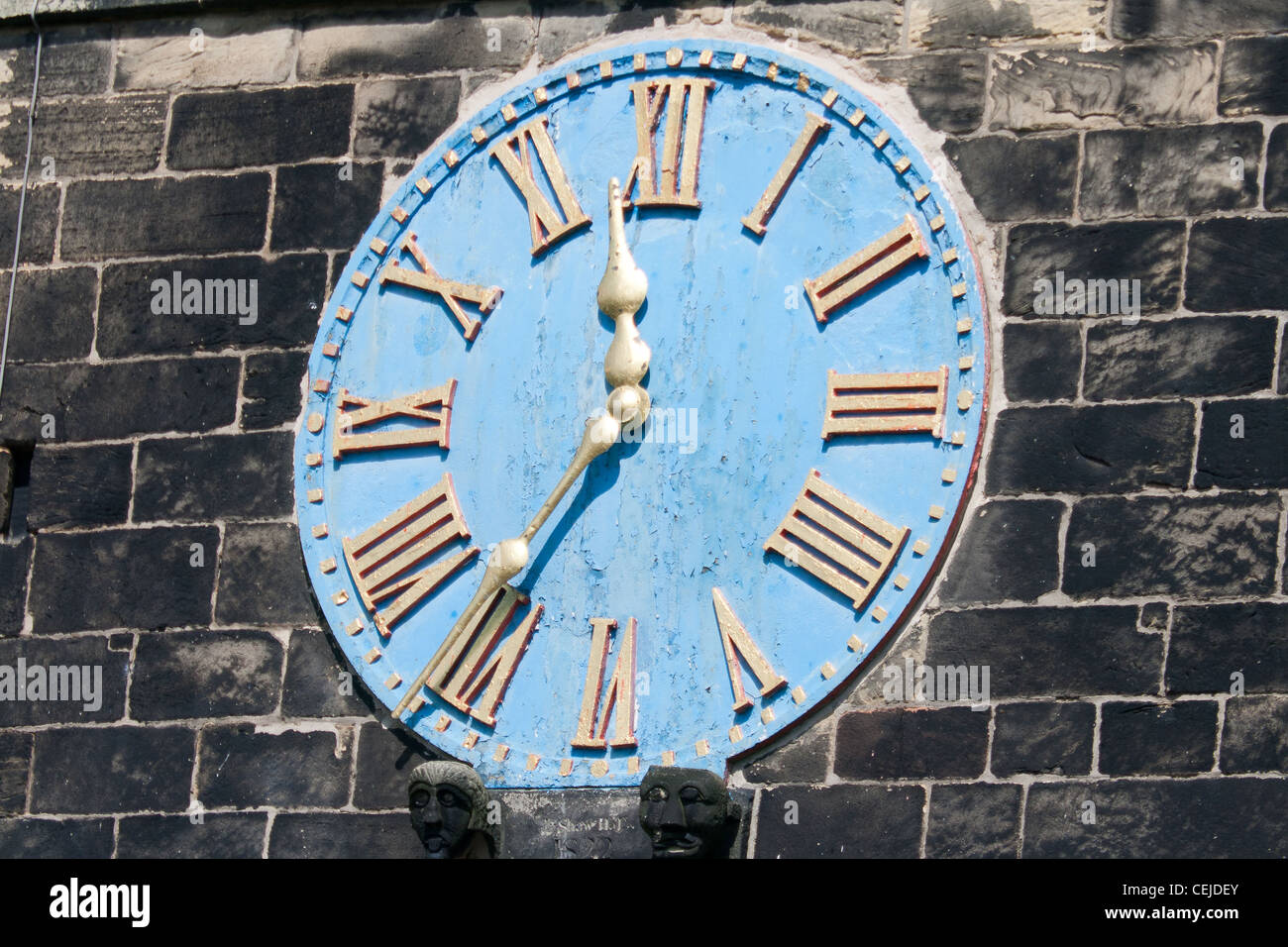 Church Clock with a blue face and roman numerals Stock Photo