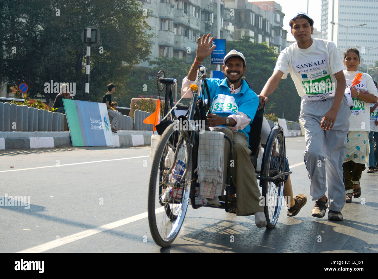 Handicapped Participant in 2008 Mumbai Marathon, waving at the Camera Stock Photo