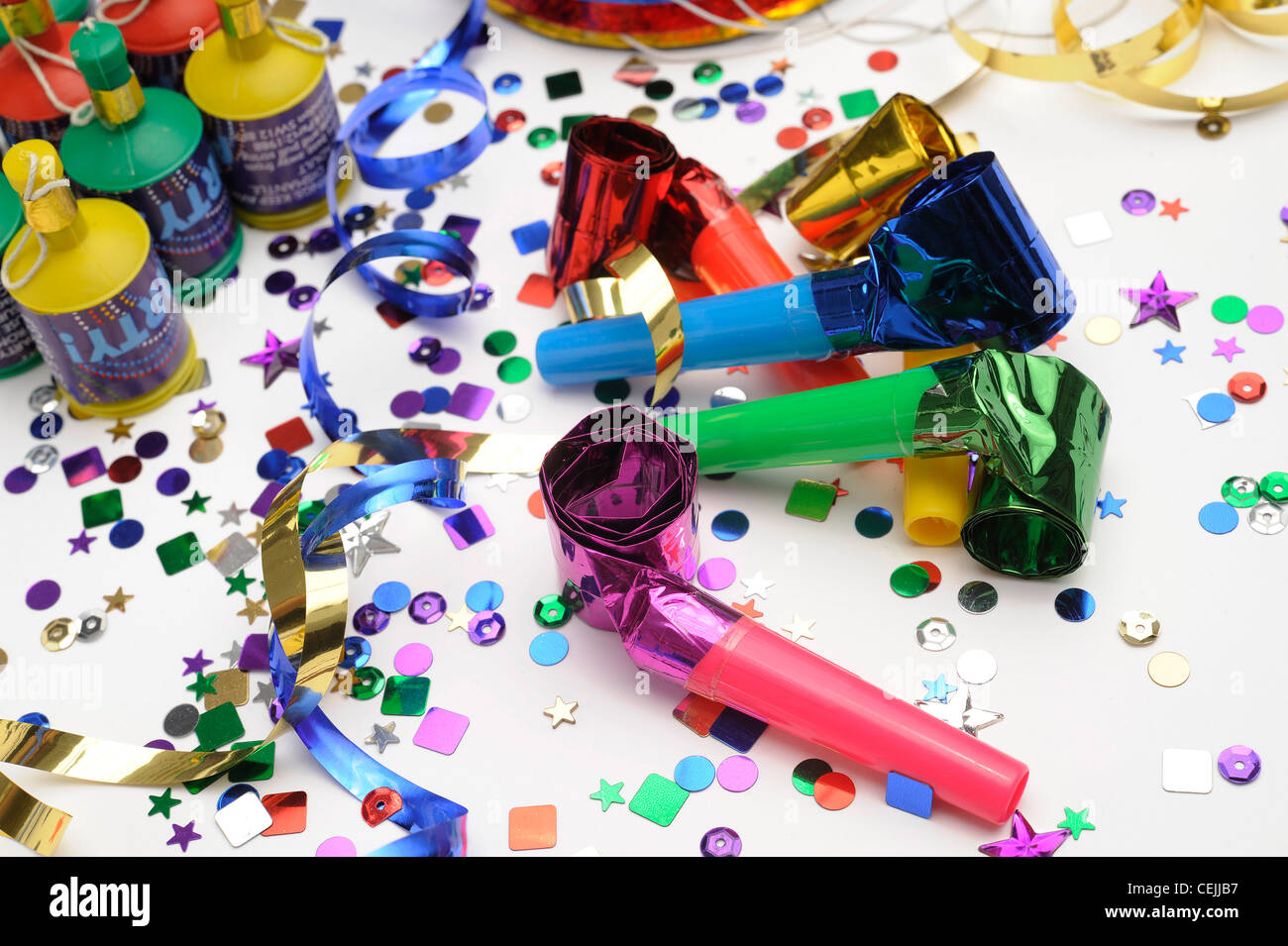 A still life image of colourful confetti, horn blowers, streamers and