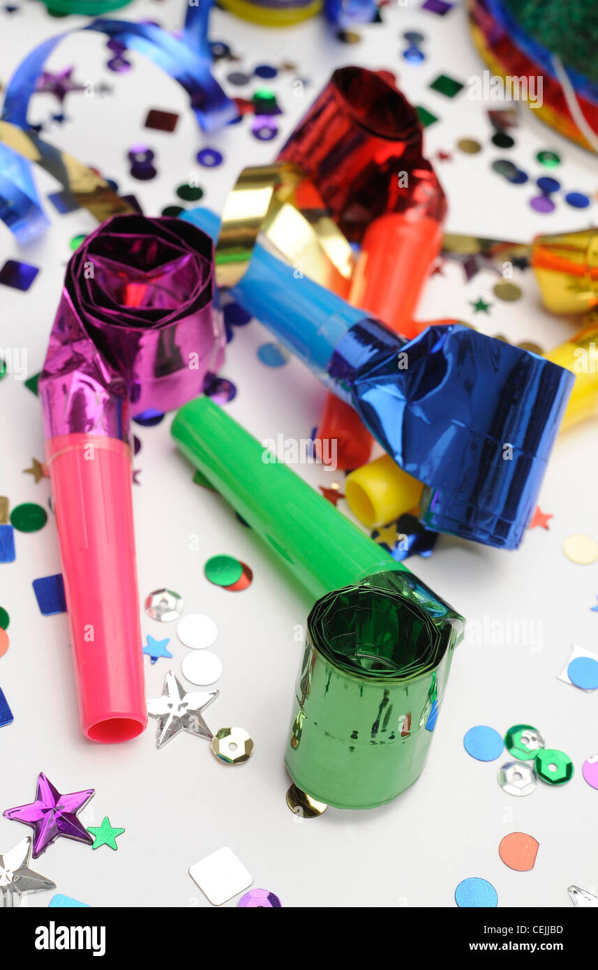 A still life image of colourful confetti, horn blowers and streamers on
