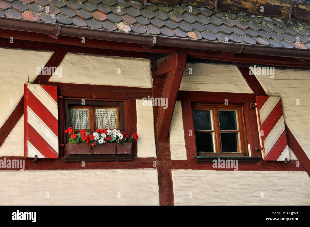 A Bavarian styled windows on a centuries old timber-framed buildings with a window sill box of geraniums in Nuremberg, Germany Stock Photo