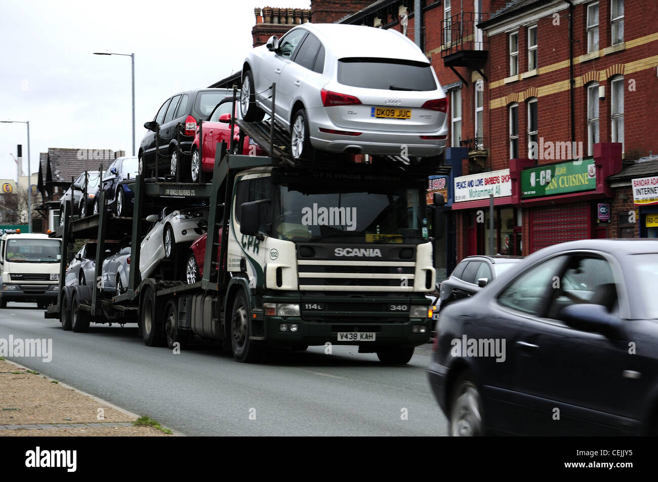 Car transporter traveling along Princess Parkway out of Manchester