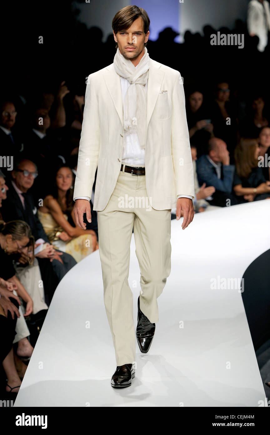 John Varvatos Milan Ready to Wear Spring Summer Male wearing cream trouser  suit, accessorized with scarf Stock Photo - Alamy