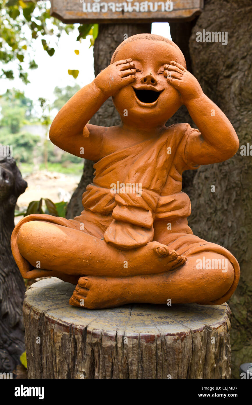 statue of a cute little monk in temple Thailand Stock Photo