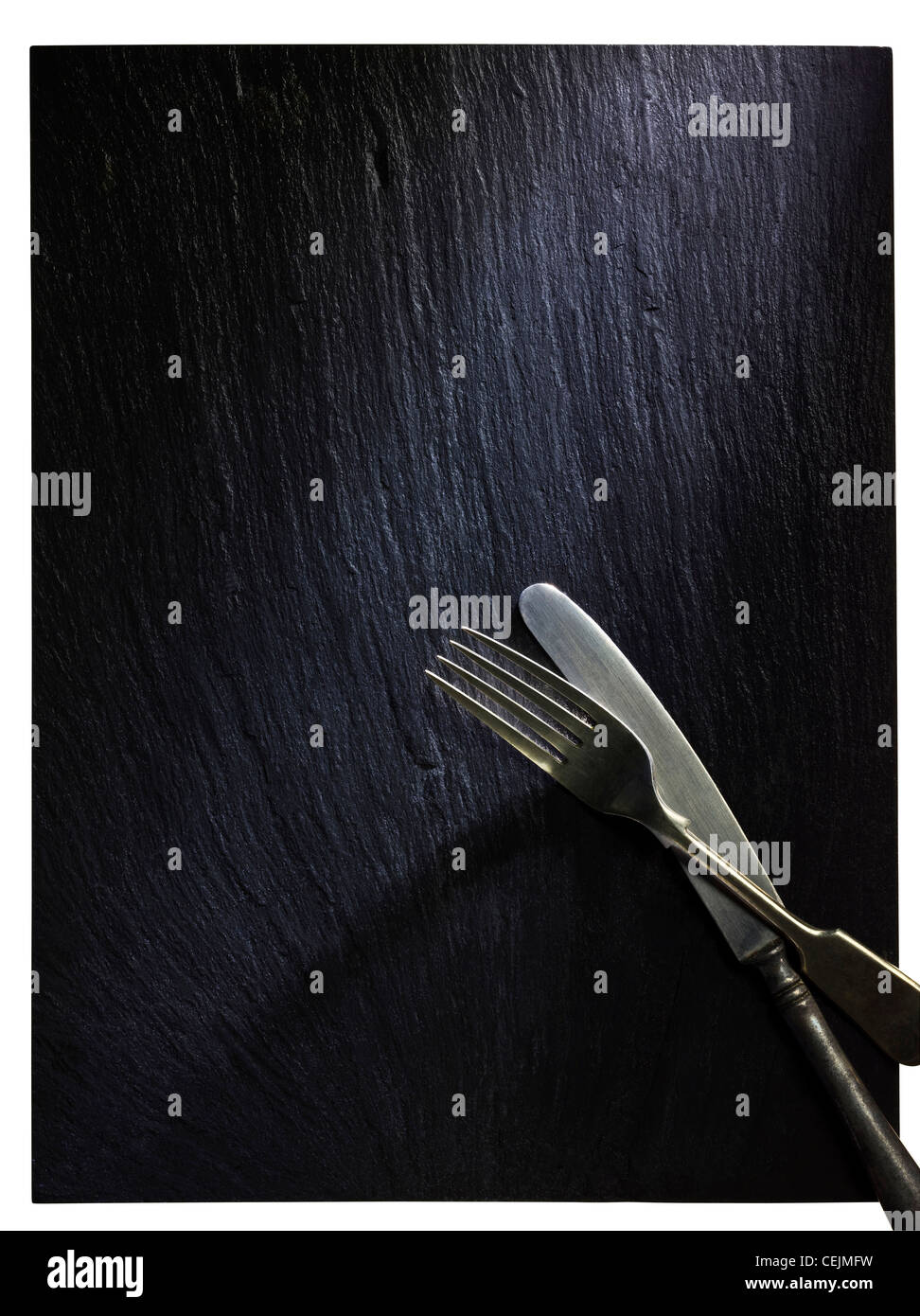 Slate with Knife and Fork shot with professional medium format digital leaf back. Stock Photo