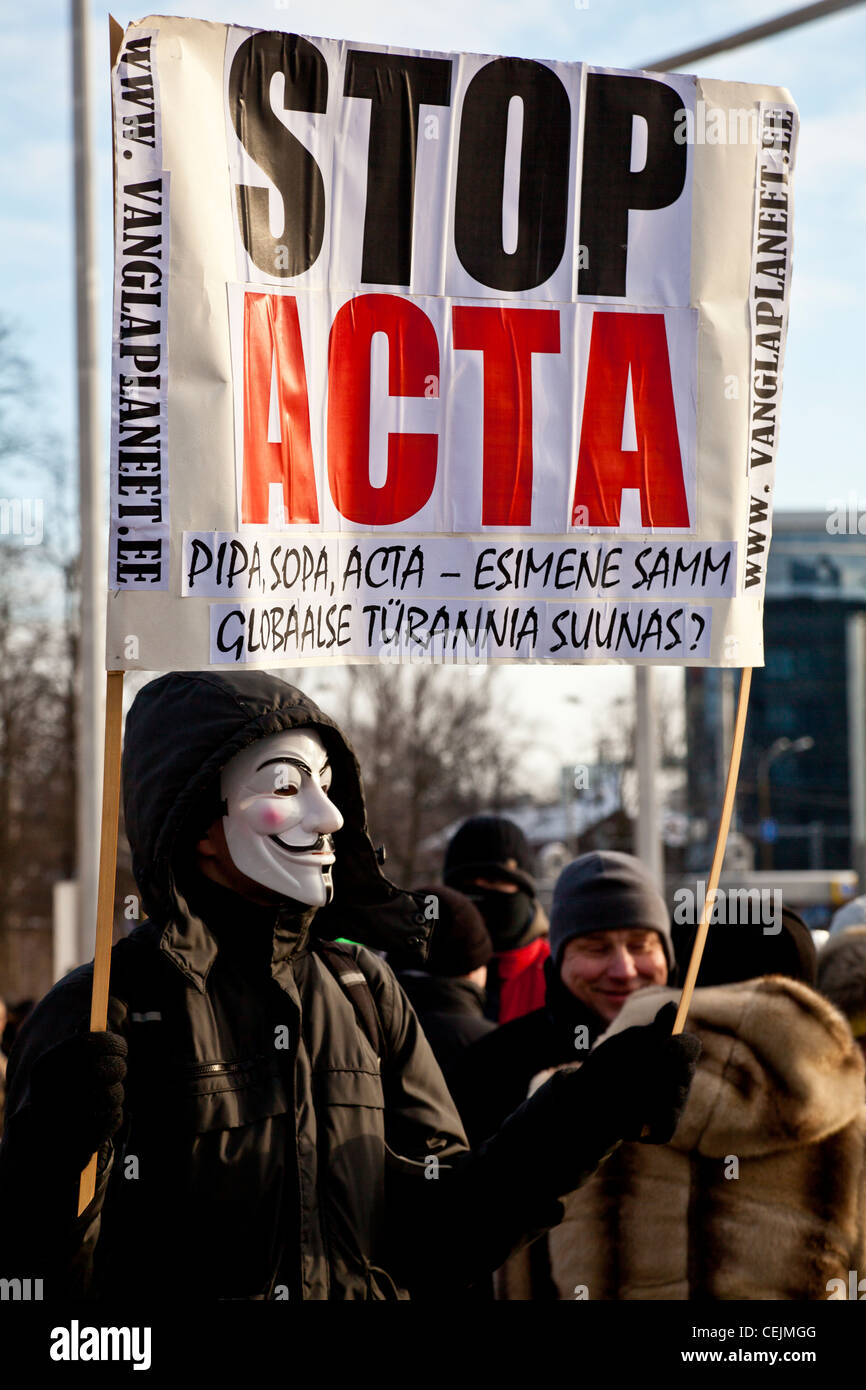 A protester holding a 'Stop ACTA' sign while wearing a Guy Fawkes mask in Tallinn, Estonia Stock Photo