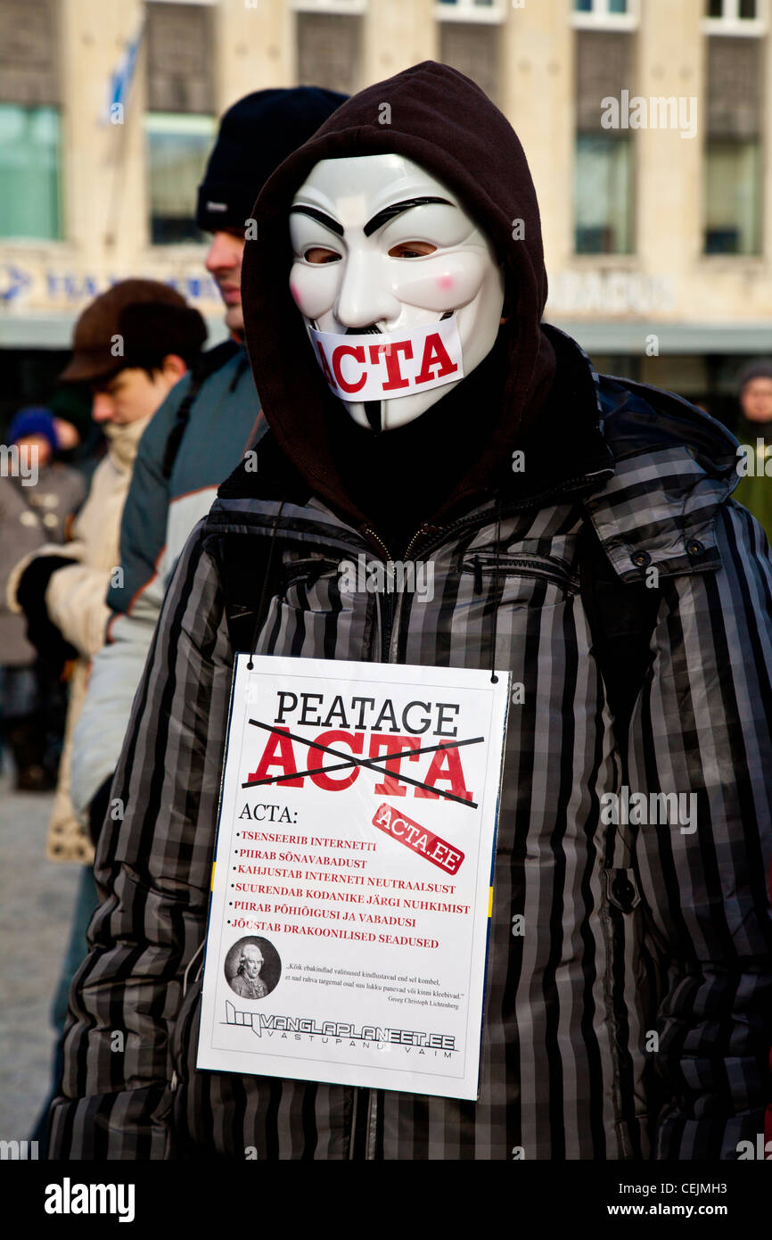 Protester wearing a Guy Fawkes mask and against ACTA signs in the protest in Tallinn, Estonia Stock Photo