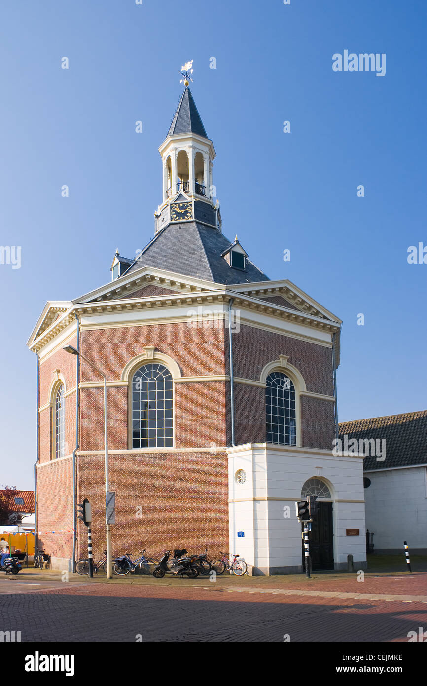 Dutch octagonal build village church in the morning sun with blue sky Stock Photo