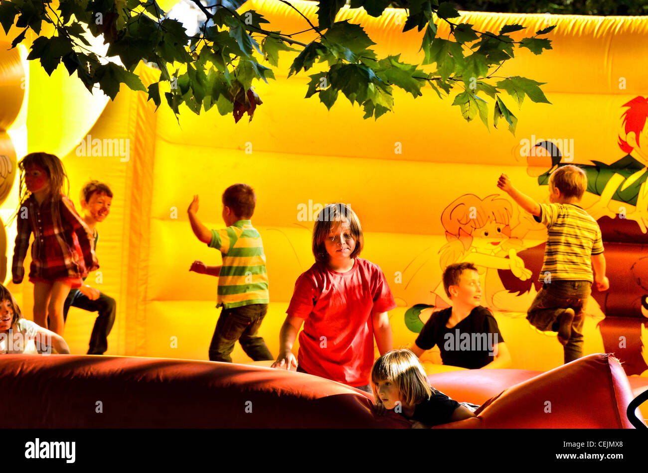 Children playing on a bouncy castle Stock Photo