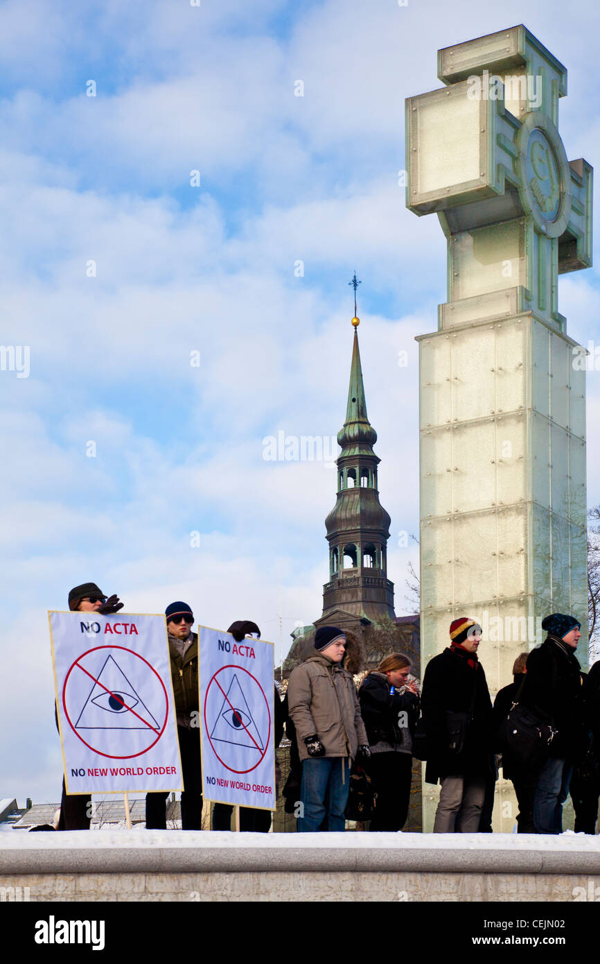 People standing in front of the Victory Column protesting against the Anti-Counterfeiting Trade Agreement in Tallinn, Estonia Stock Photo