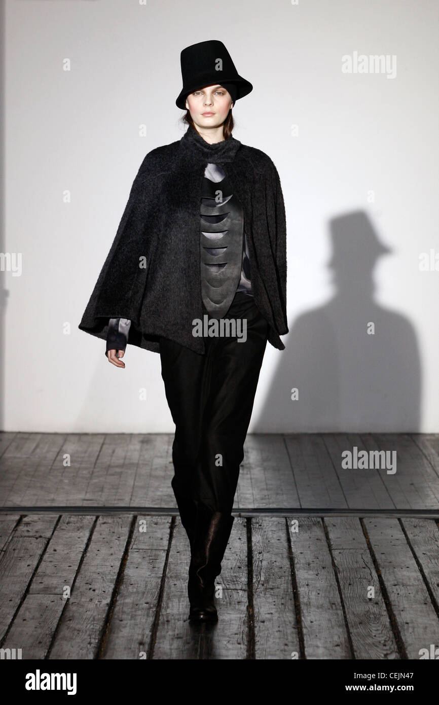 Black top hat, black cape coat with cut our leather chest, black trousers  and black ankle boots Stock Photo - Alamy
