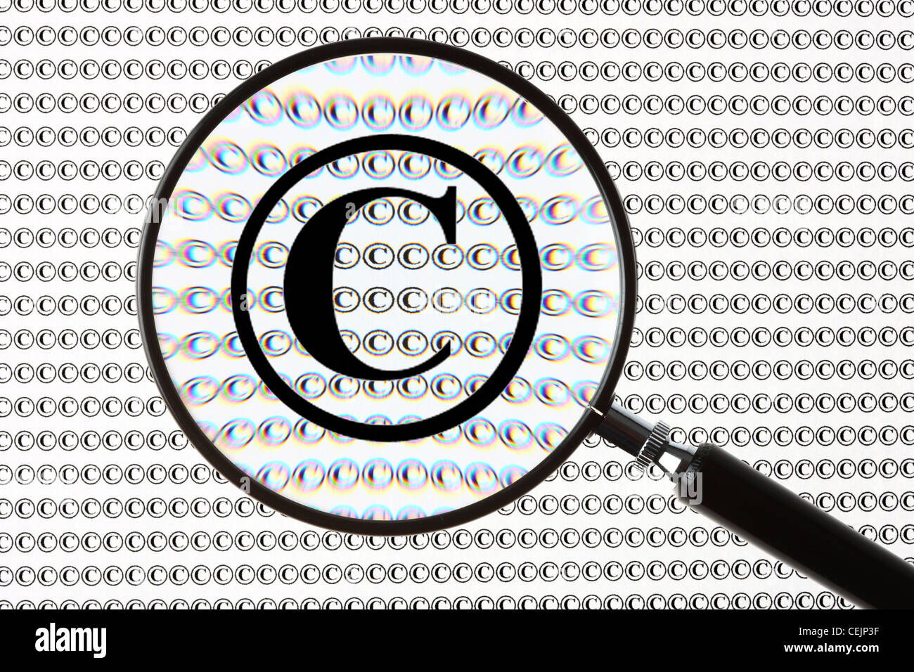 Magnifying glass highlighting a  Copyright sign,  © symbol. Symbolic image. Stock Photo