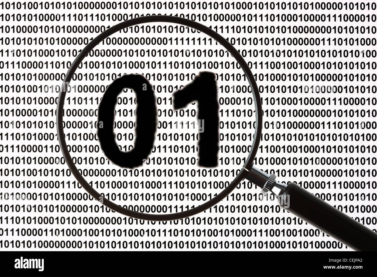 Magnifying glass highlighting a zero and one number letter, sign,  symbol for digital, digitization . Symbolic image. Stock Photo