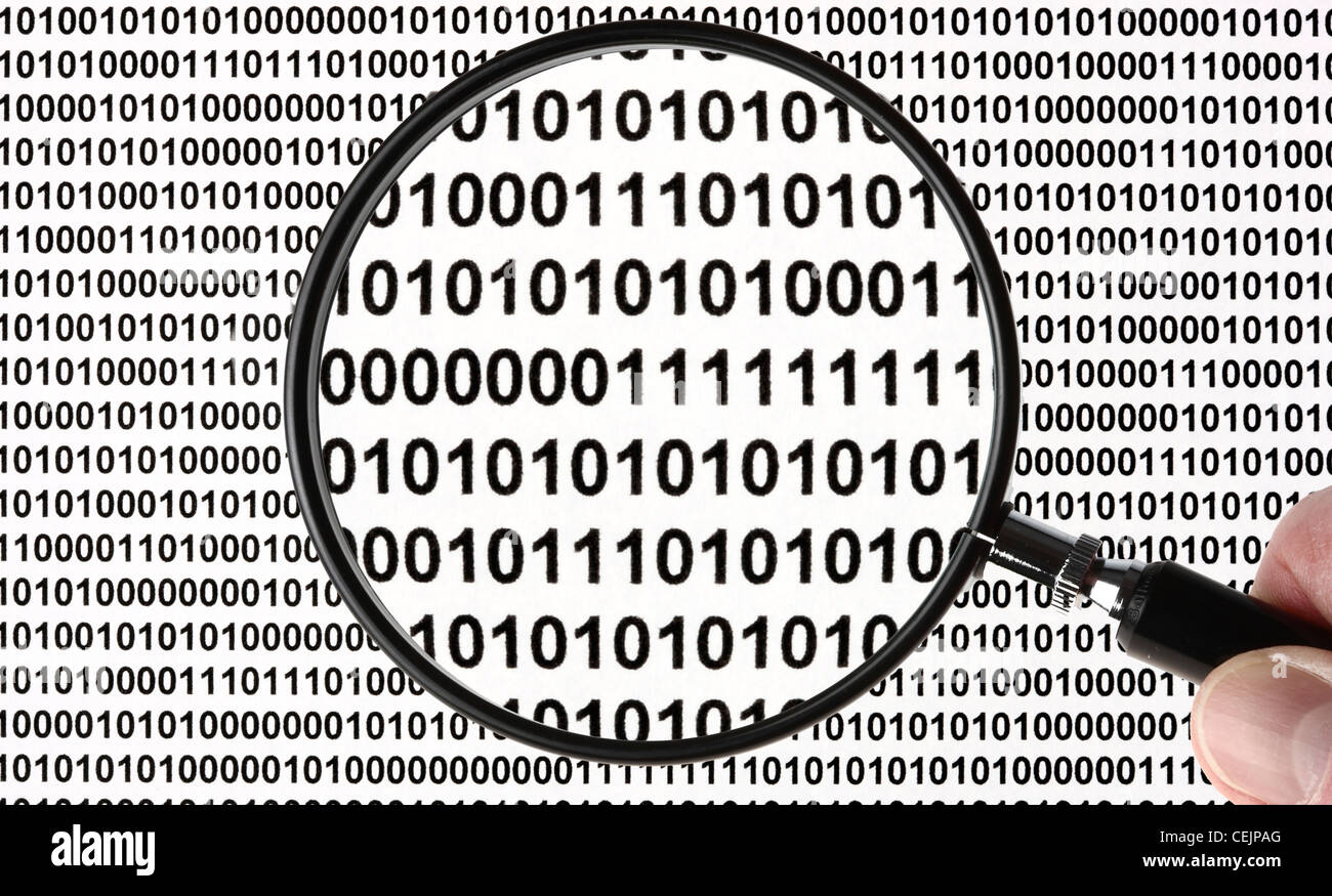 Magnifying glass highlighting a zero and one number letter, sign,  symbol for digital, digitization . Symbolic image. Stock Photo