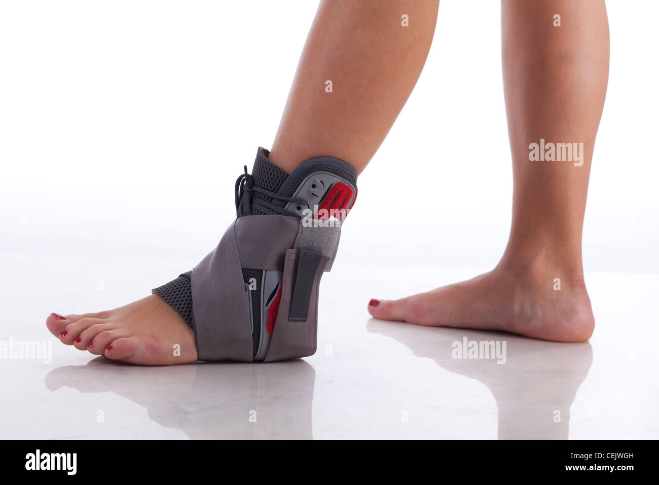 Foot Wrapped in a Ankle Brace on White with reflection Stock Photo