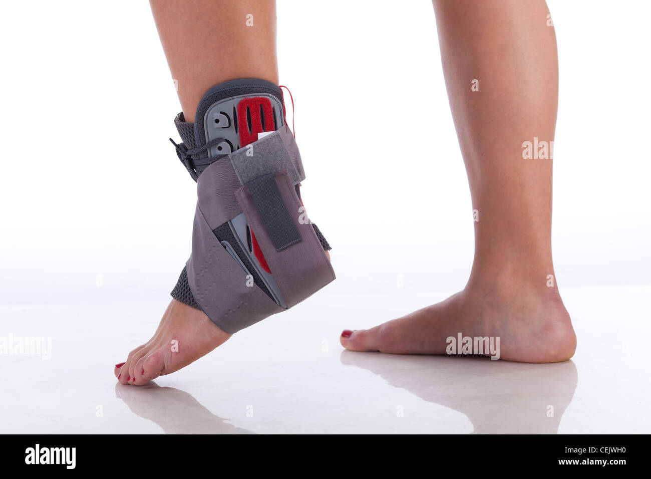 Foot Wrapped in a Ankle Brace on White with reflection Stock Photo