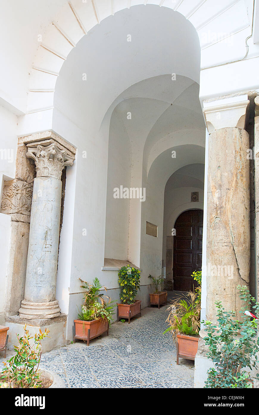 strong white stucco arches leading to door, sorrento, italy Stock Photo