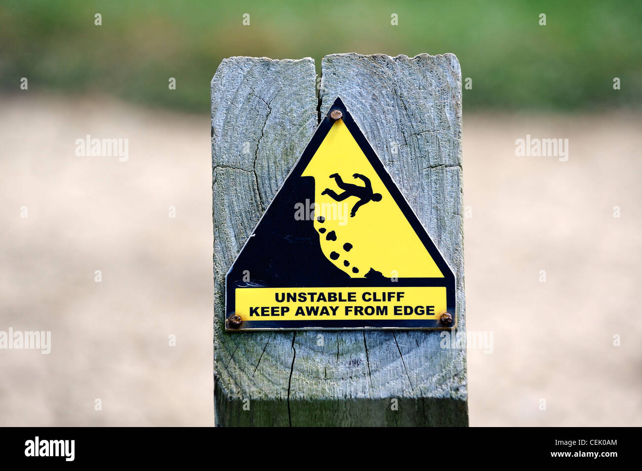 Danger warning sign on cliff edge for walkers at Godrevy Head on South West Coast Path, Cornwall, England Stock Photo